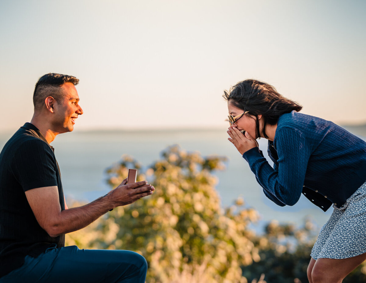 Epic reaction during a surprise proposal in Seattle, Washington at golden hour during the summertime. Captured by Maë Lans Photography.