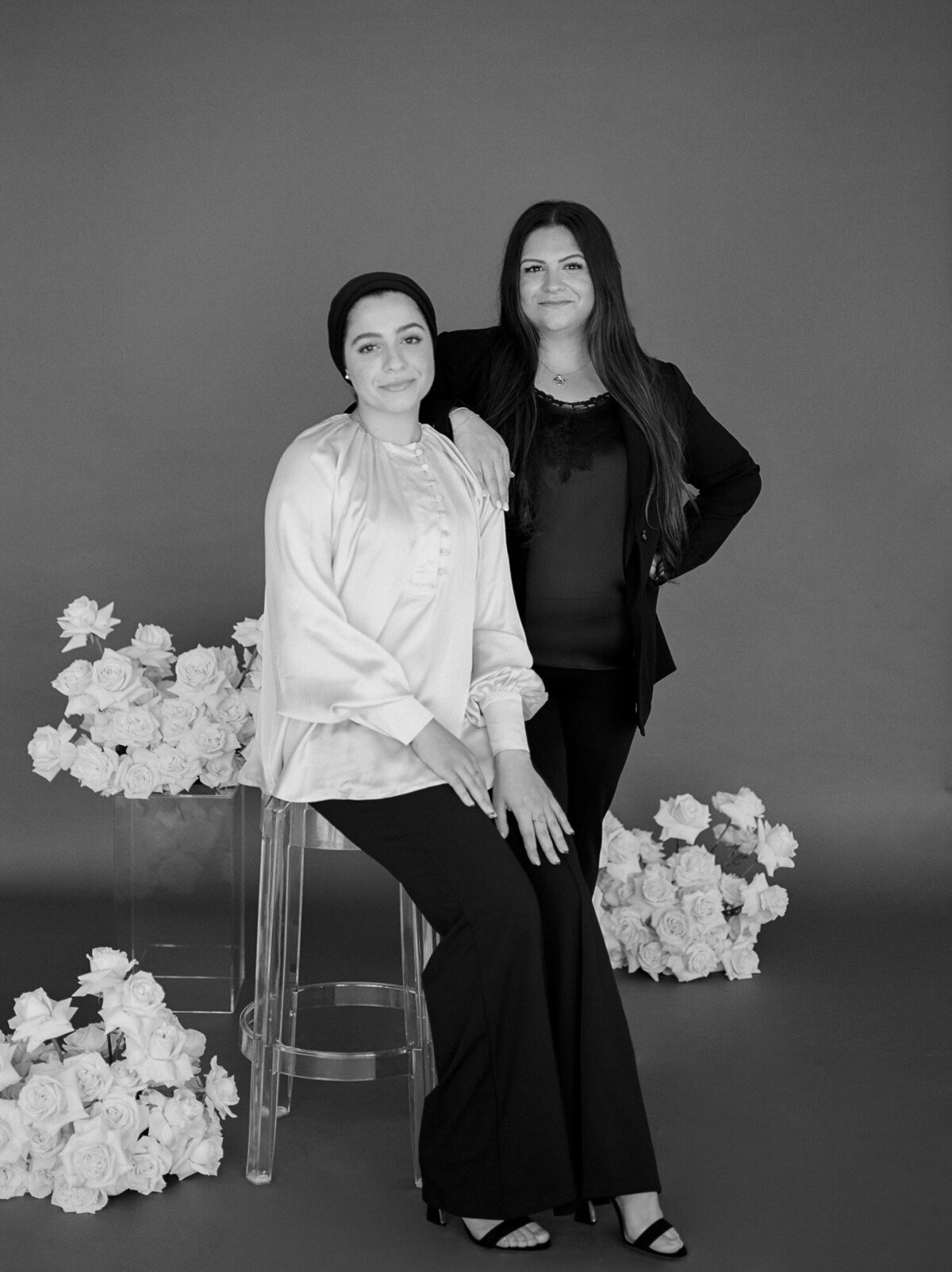 two women with white roses, dark background, florist branding photos, headshots