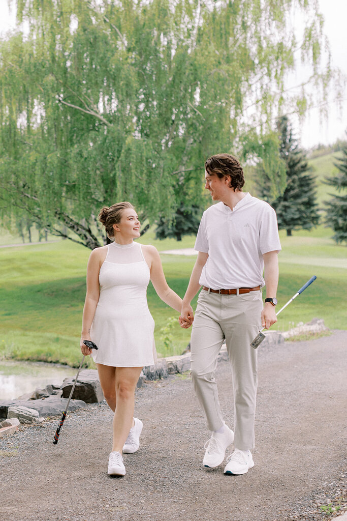 Couple golfing at Sugar Pine Island, a romantic wedding venue in Foothills, Alberta, featured on the Brontë Bride Vendor Guide.