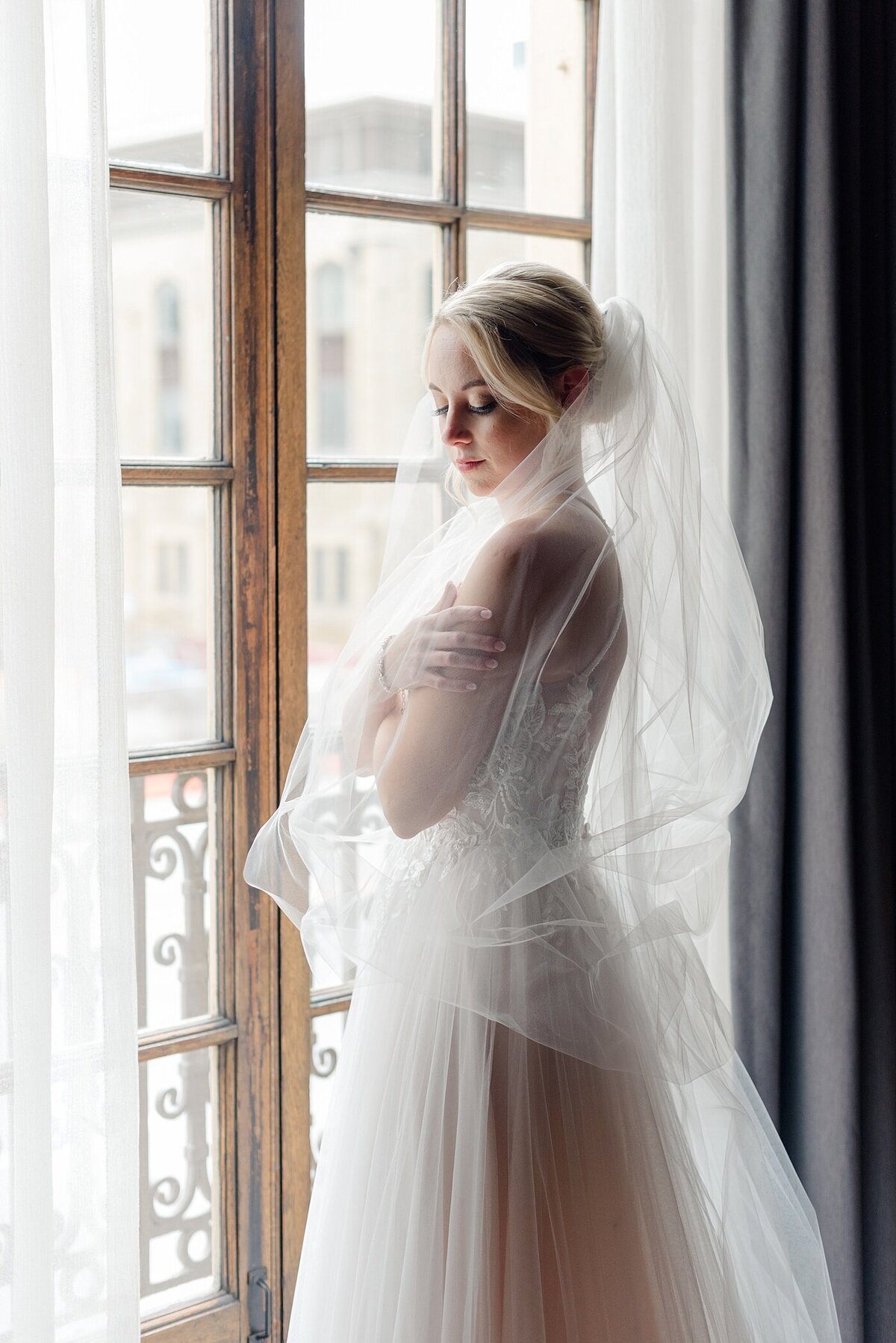 Bride posing by window at Athletic Club of Columbus taken by Columbus, Ohio Wedding Photographer