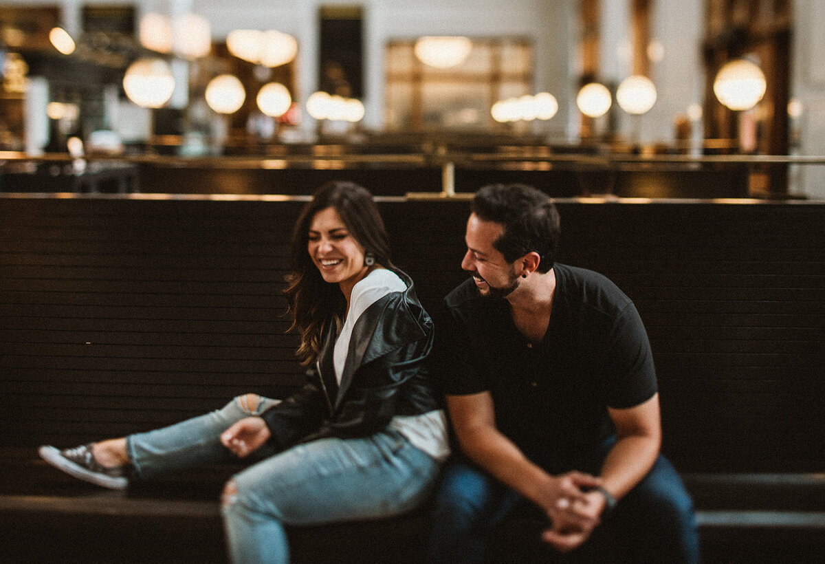 man and woman laugh in union station colorado 