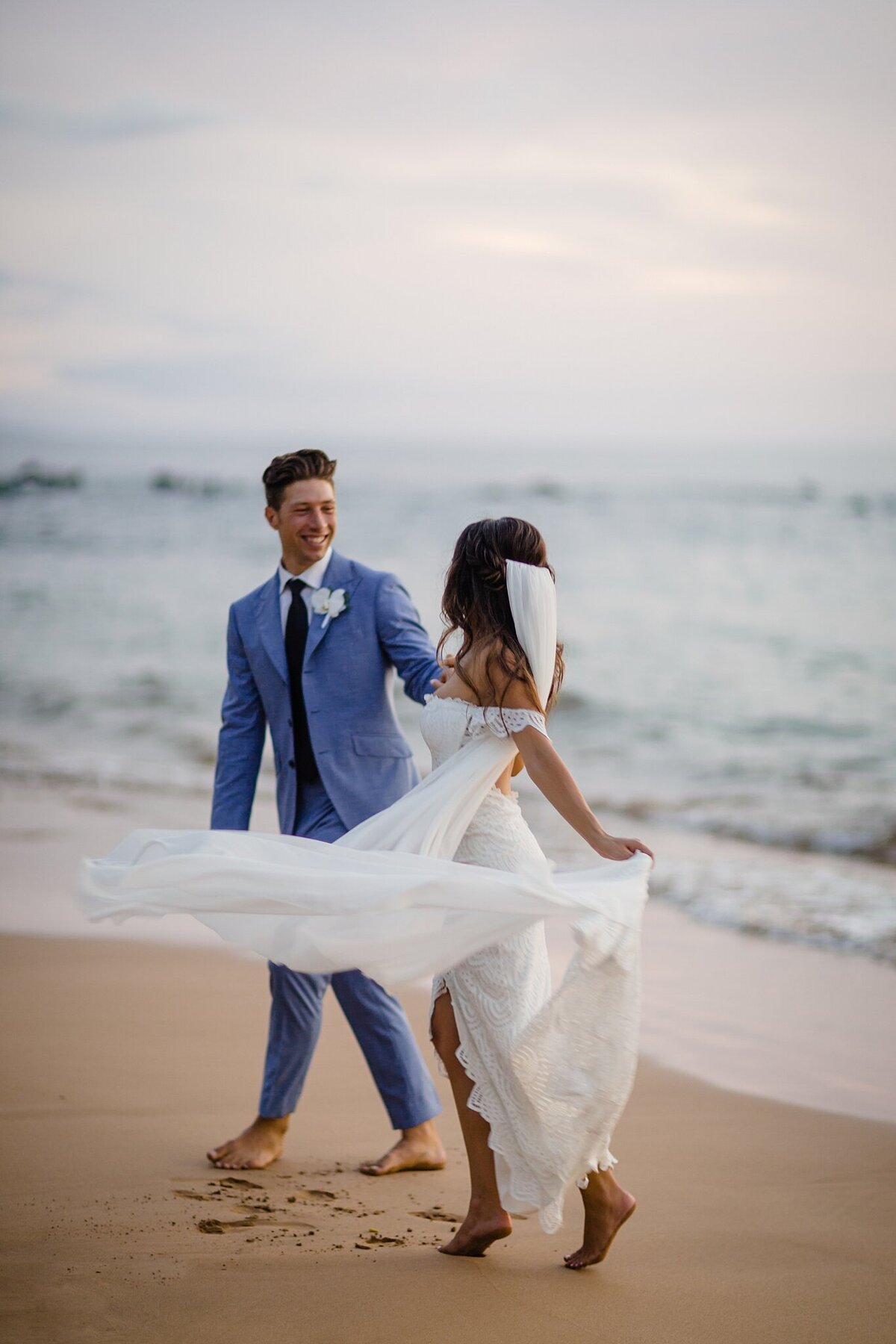 bride and groom dancing in the sand