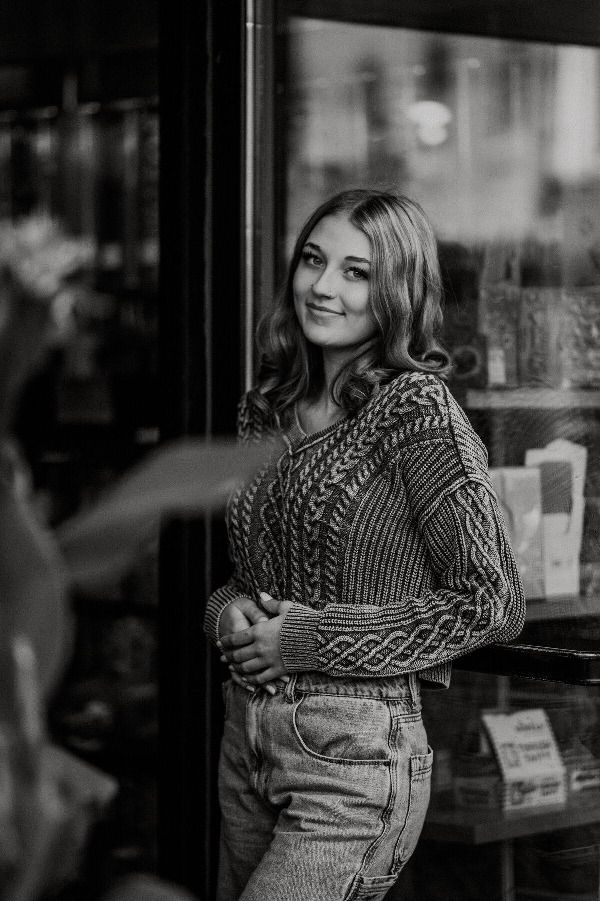 Female standing in a doorway of shop in downtown Stillwater.