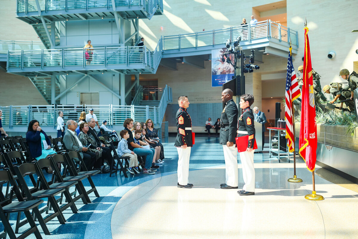 united states marine retirement ceremony with american flag and people watching in the background
