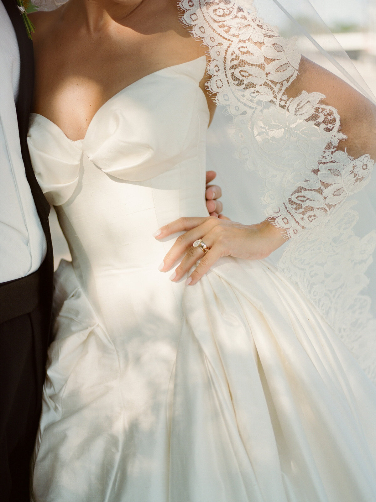 stunning detail of a Leah Dagloria wedding dress and lace mantilla veil, captured by film wedding photographer Christina Harrison