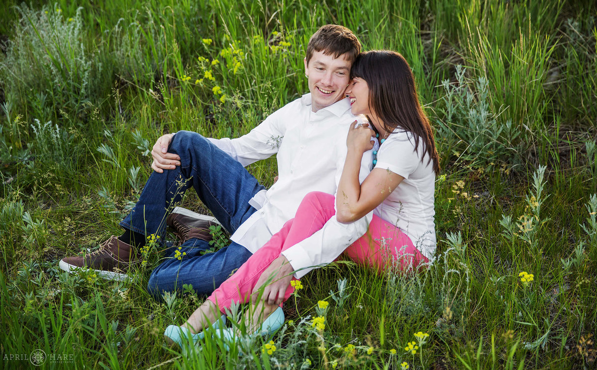Snuggling in the wildflowers engagement photo at Golden Gate Canyon State Park
