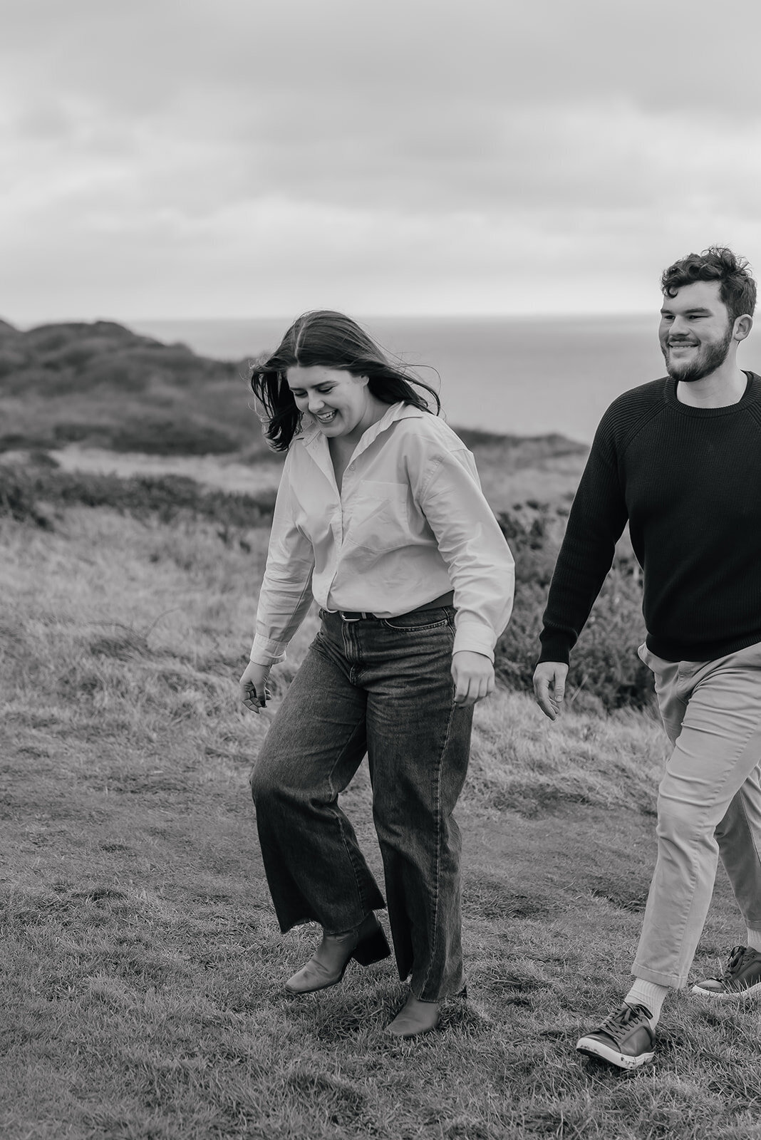 Close up of couple walking hand in hand on Beachy Head