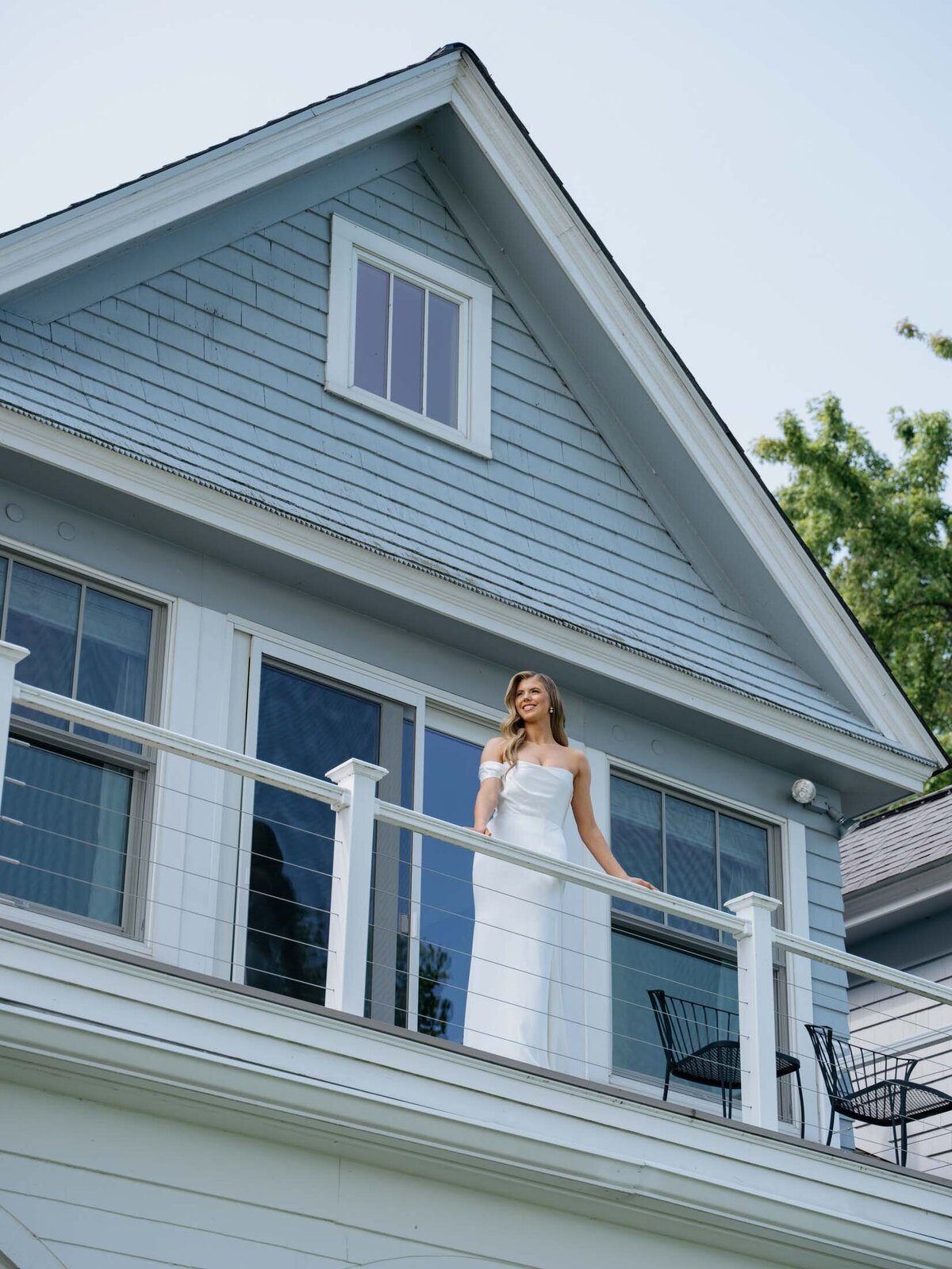 Bride looking out at the lake from a balcony