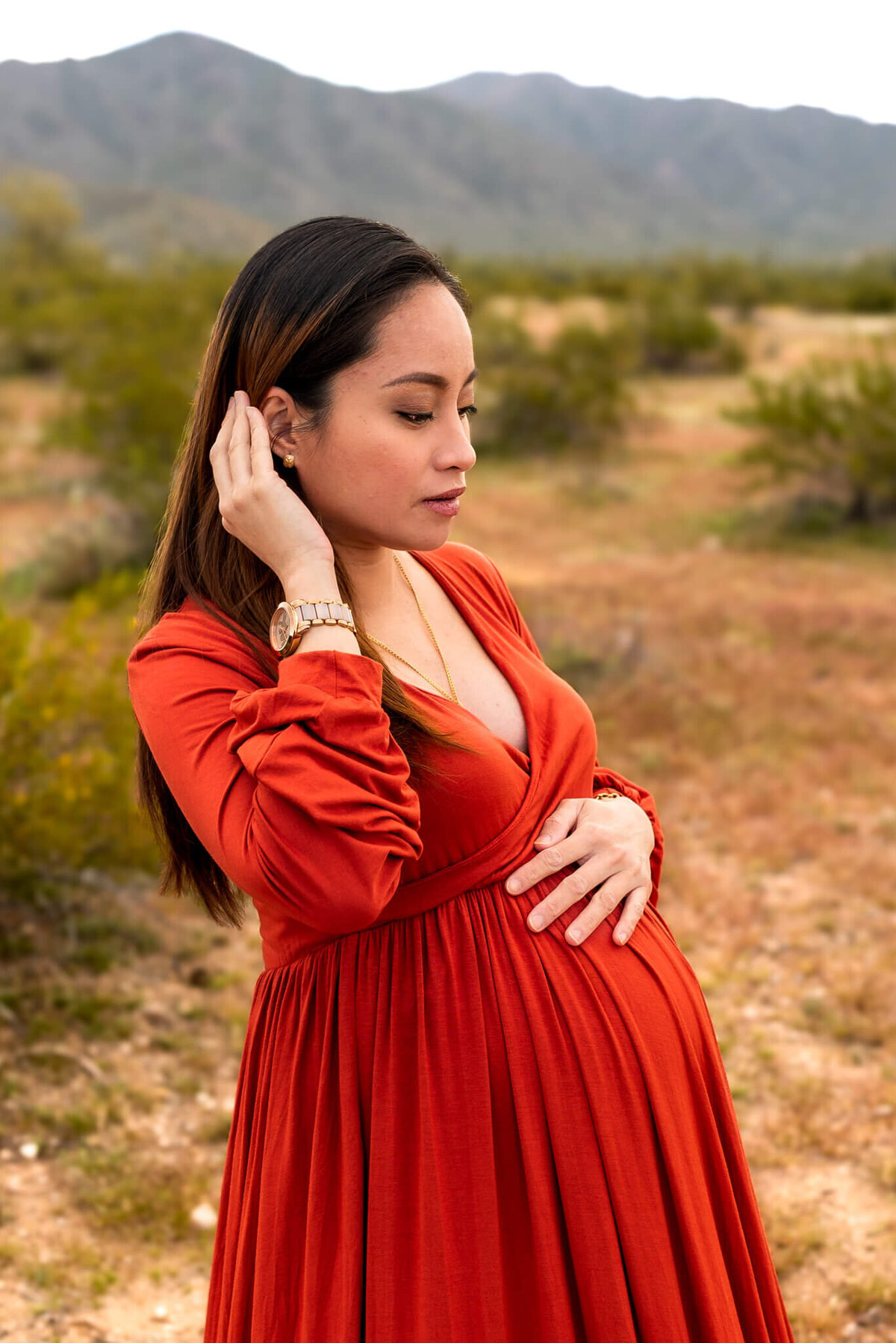 Beautiful Close up portrait of Mom-to-Be in rust red dress. Captured by Cactus & Pine Photography