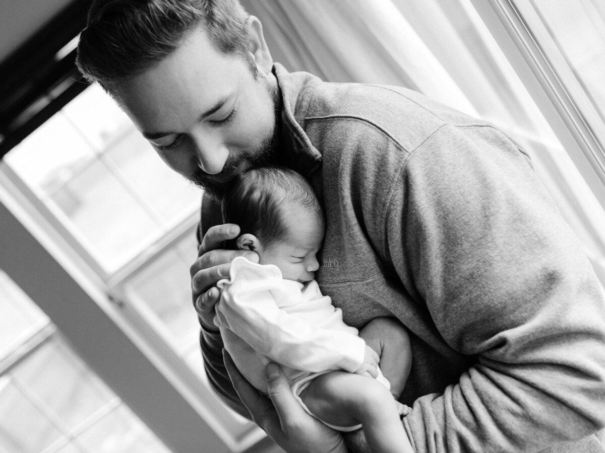 dad holding newborn baby girl