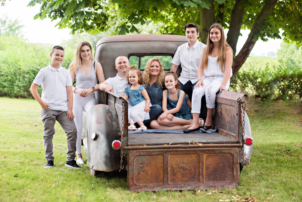 Family of 8 sitting in the back of a vintage truck for their family photos in Burlington, Ontario
