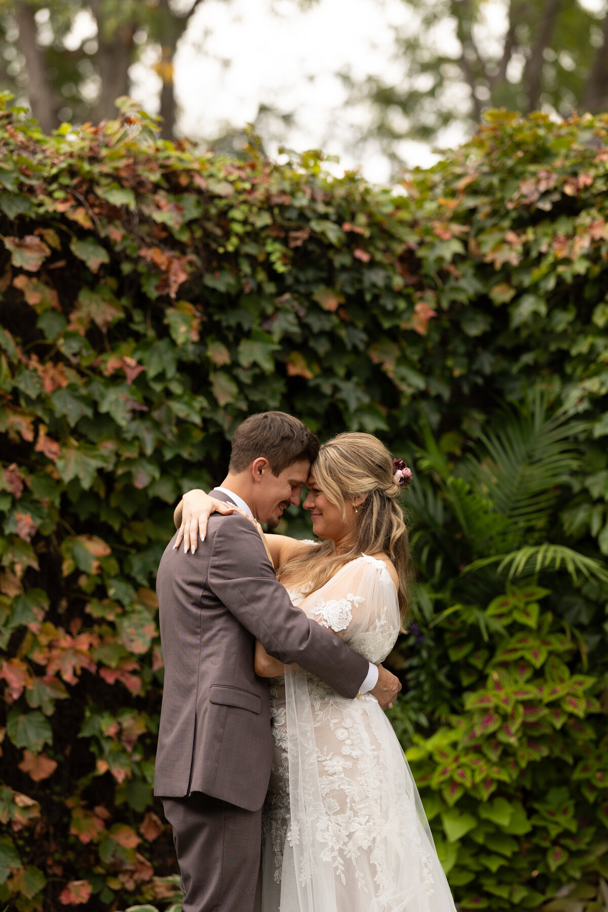 A bride and groom smile at each other in this natural light, bright, true-color wedding photography by Claire Katan Creative.