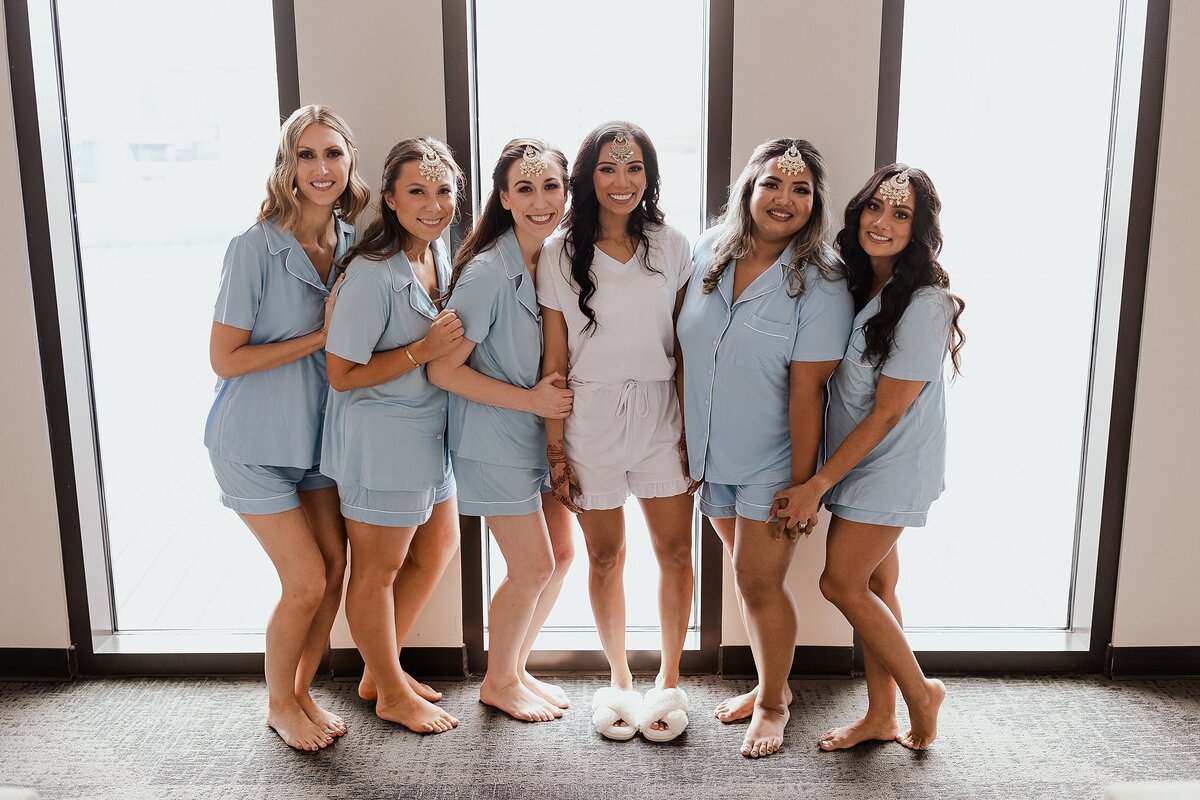 Indian bride and her Hindu bridesmaids wear light blue pajamas as they get reading for the Indian wedding in Nashville at the Country Music Hall of Fame.