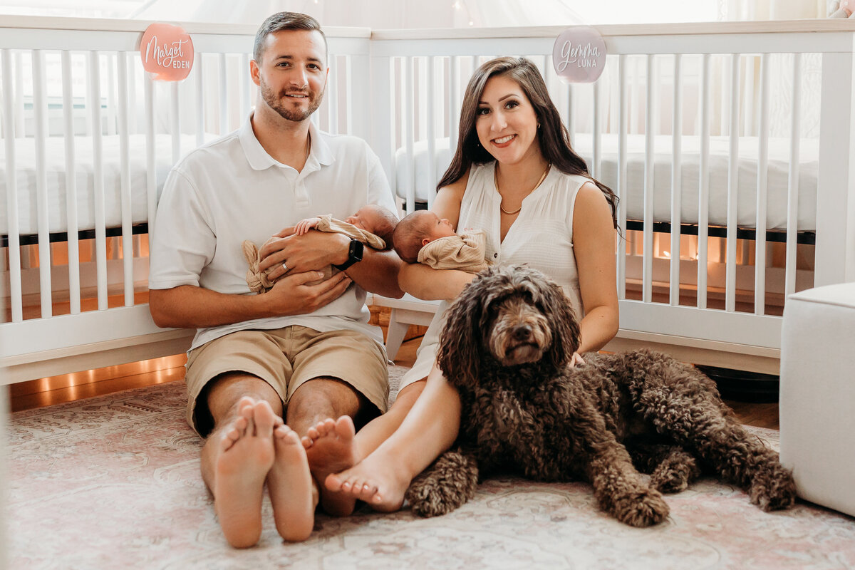 mom and dad with newborn baby girl twins and golden doodle dog by harrisburg pa newborn photographer