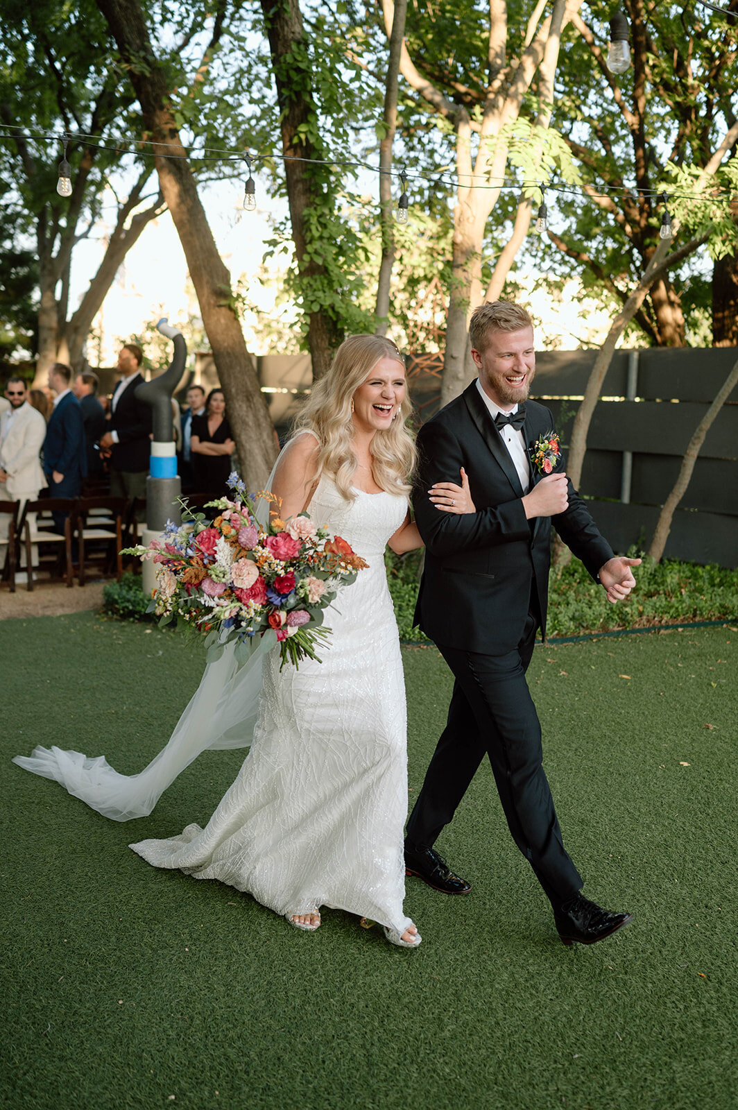 bride and groom smiling after walking down the aisle after their wedding ceremony