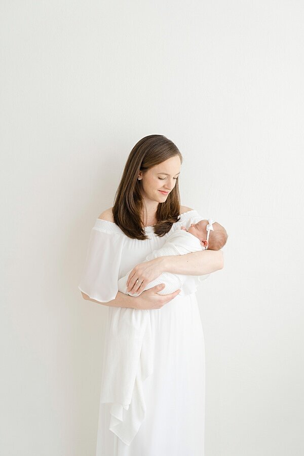 Mom in white holding baby by Louisville Portrait Photographer