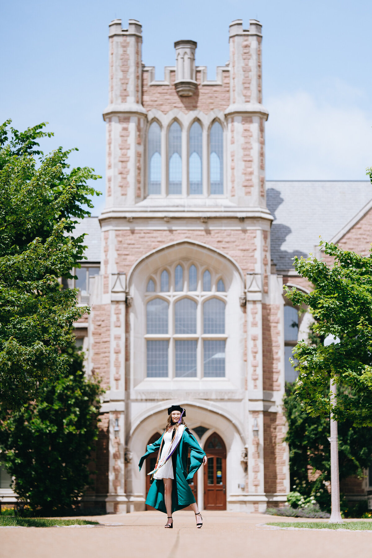 wash grad posing in front of law building in regalia