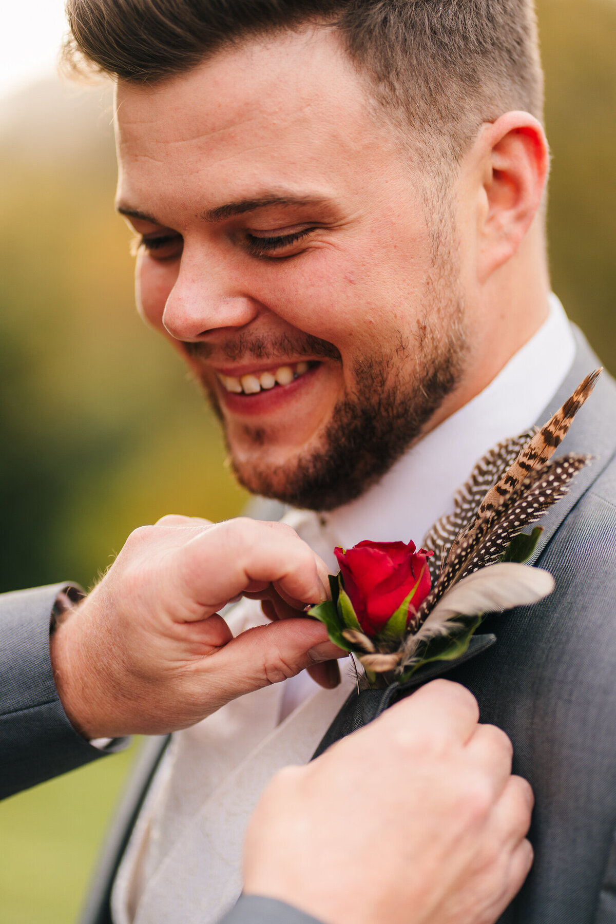 Grooms father placing button hole on groom at Merewood Country House Hotel takne by Documentary Wedding Photograpgher Anthony Horseman