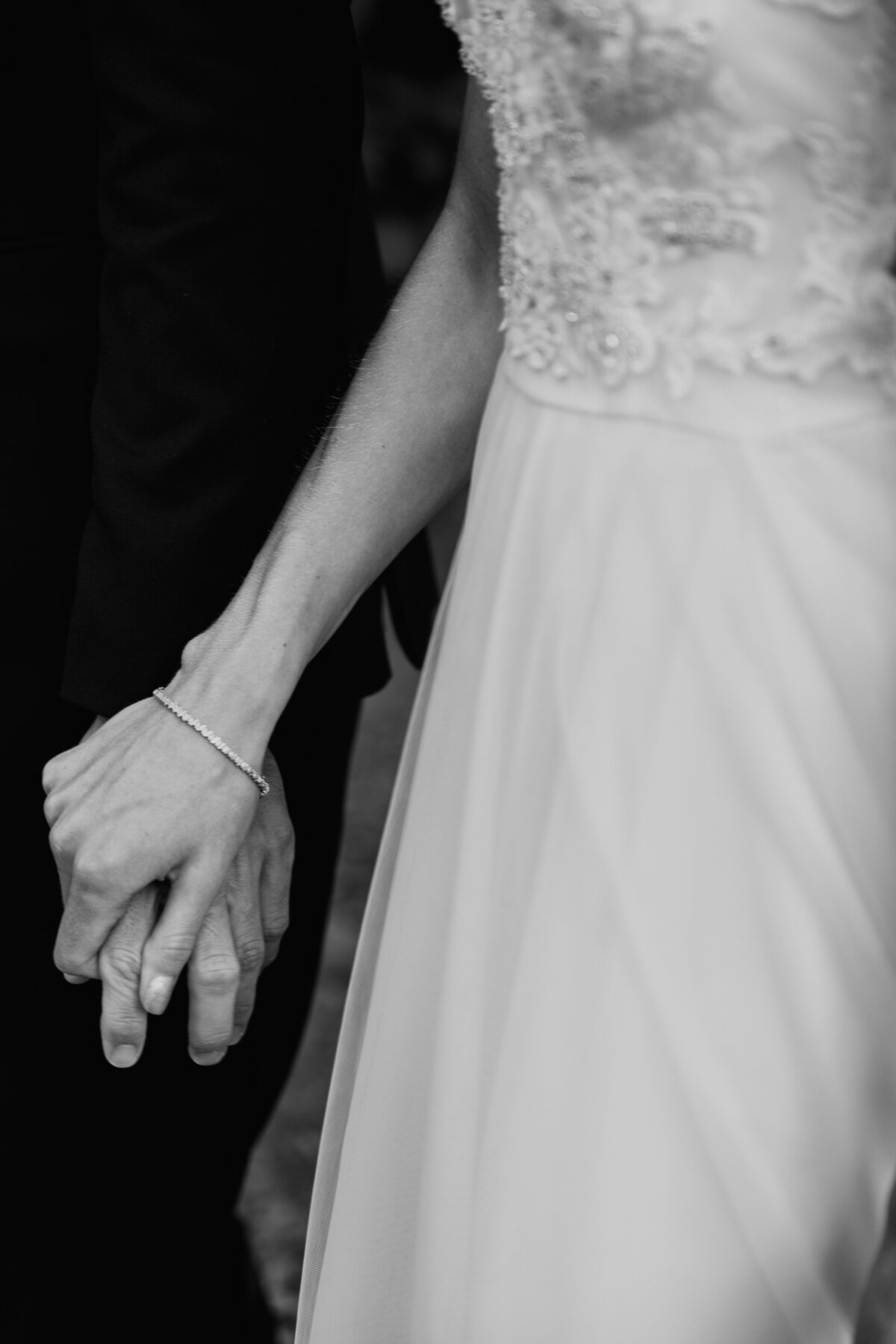 Bride and groom holding hands during vow exchange