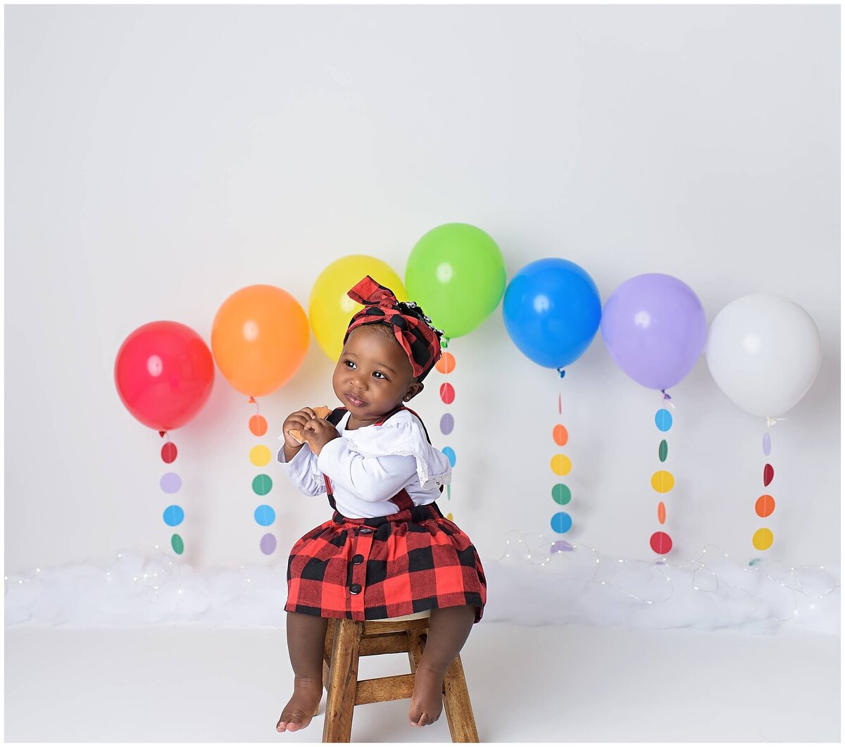 A toddler's studio portrait highlighting their captivating smile and expressive eyes.