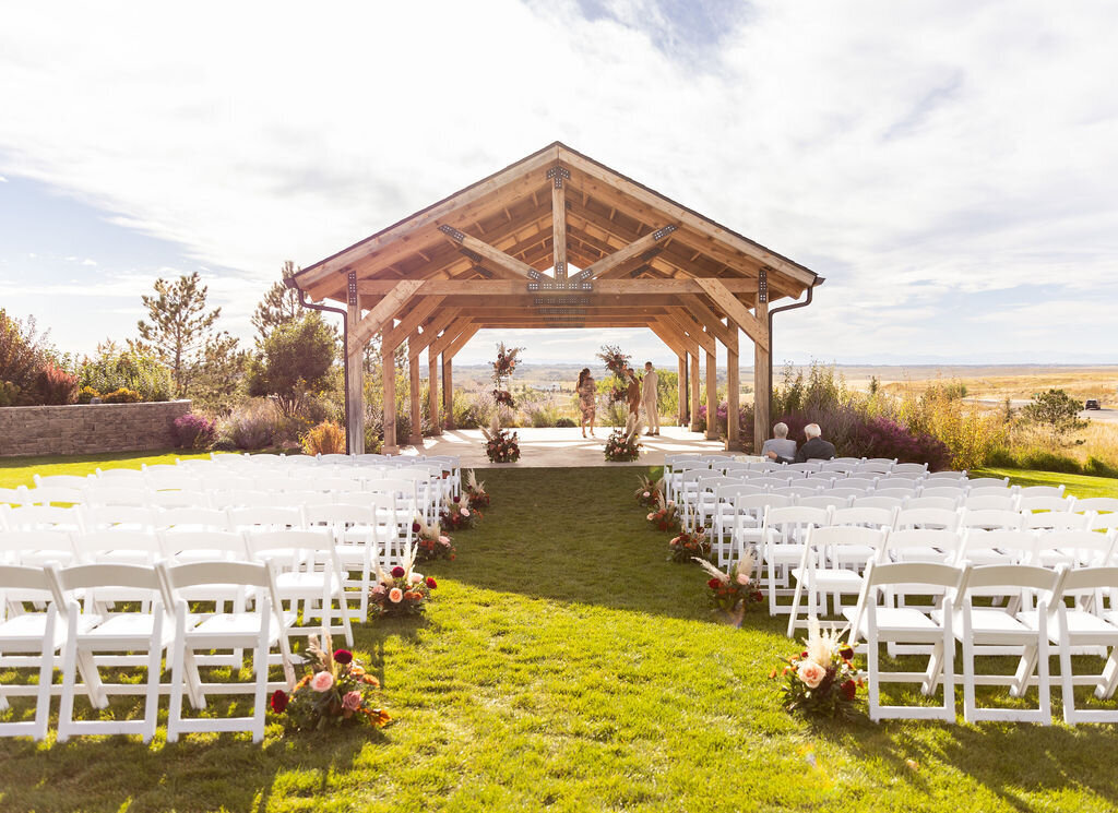 Fall colored flowers down the aisle for a wedding ceremony setup at Bonnie Blues Event Venue.