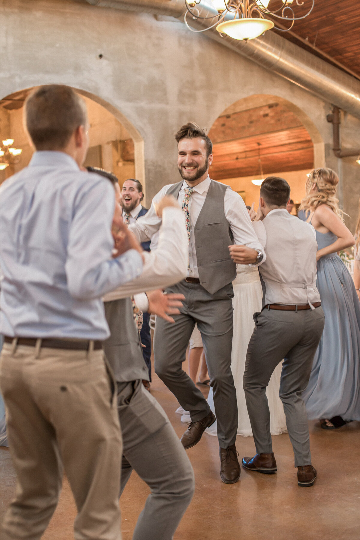 The rest of the wedding party jumps on the dance floor to celebrate the marriage of the bride and groom