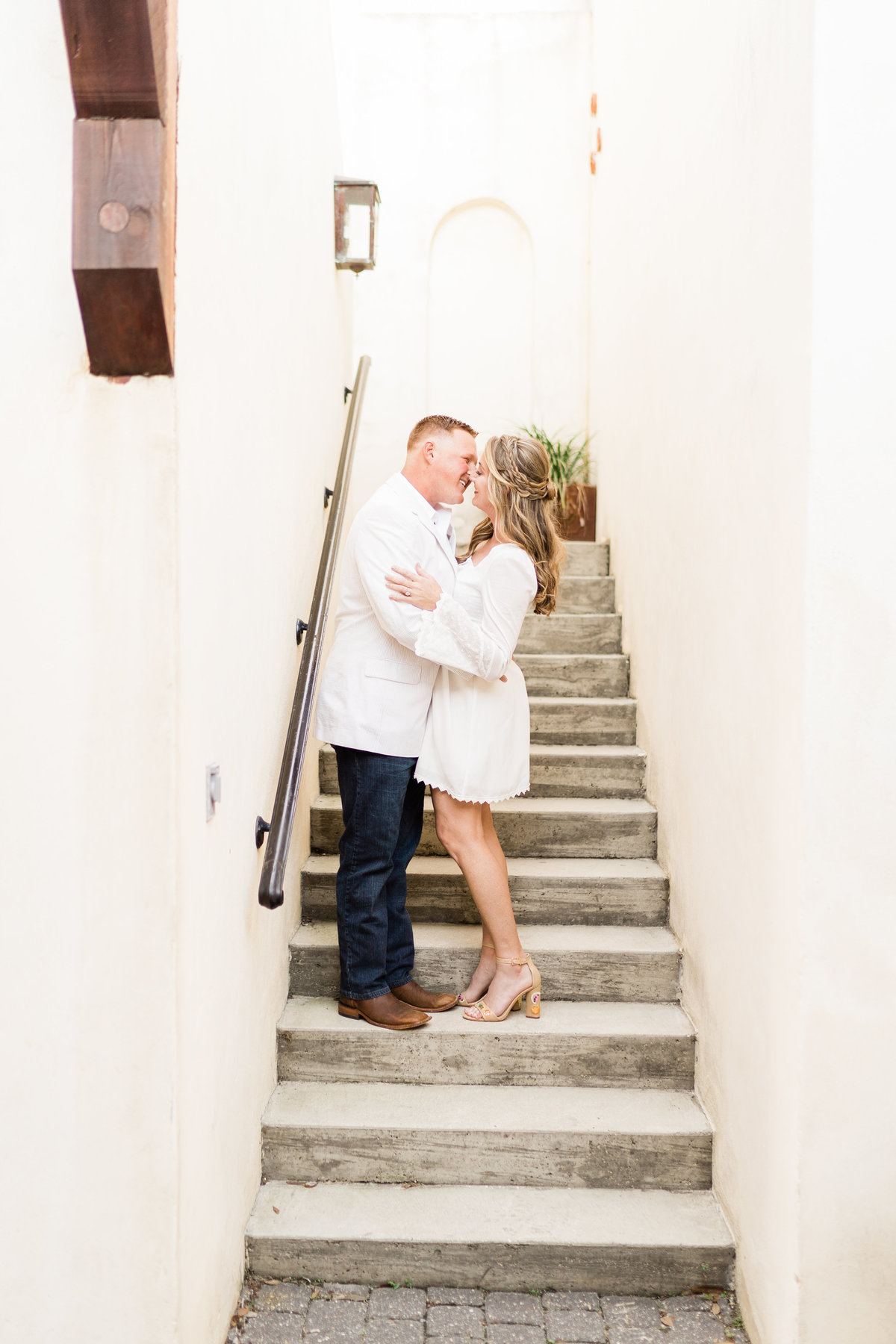 Couple posing on stairs for engagement photoshoot in Alabama