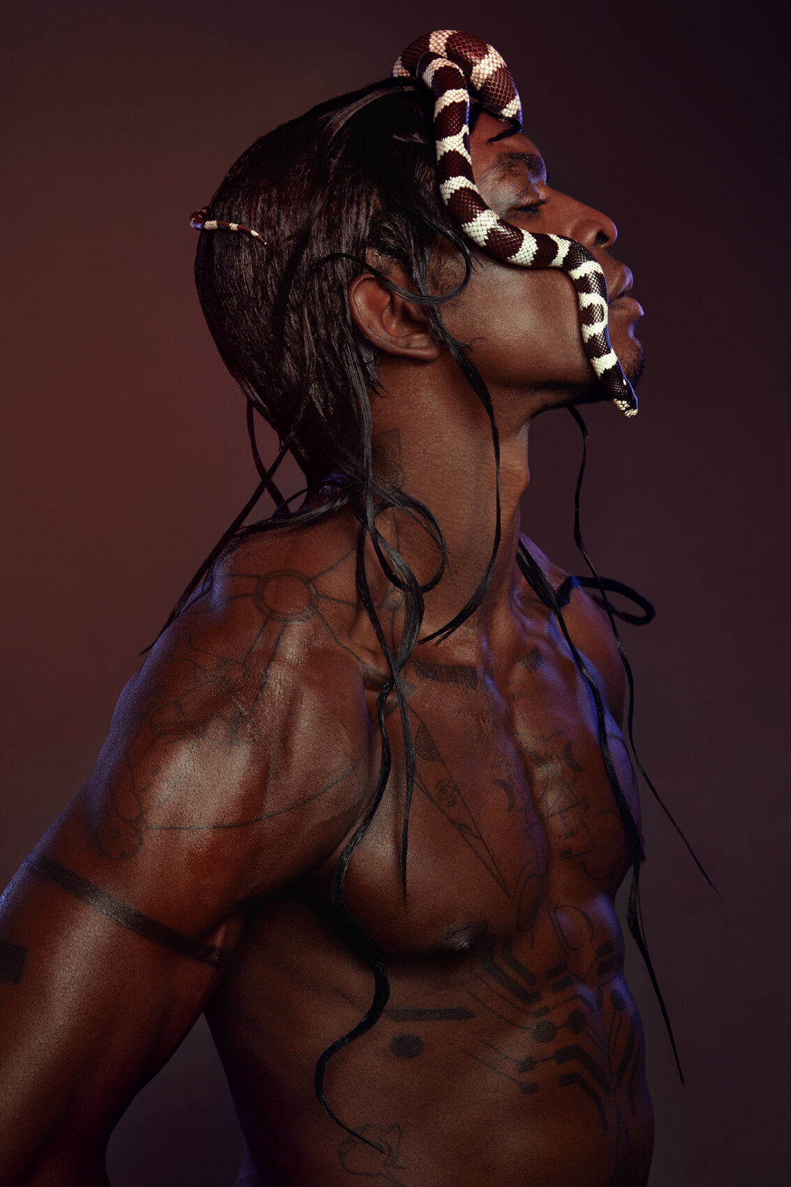 Dramatic portrait of Jonzu, adorned with pearls, captured by Ylva Erevall in a bold artistic style.