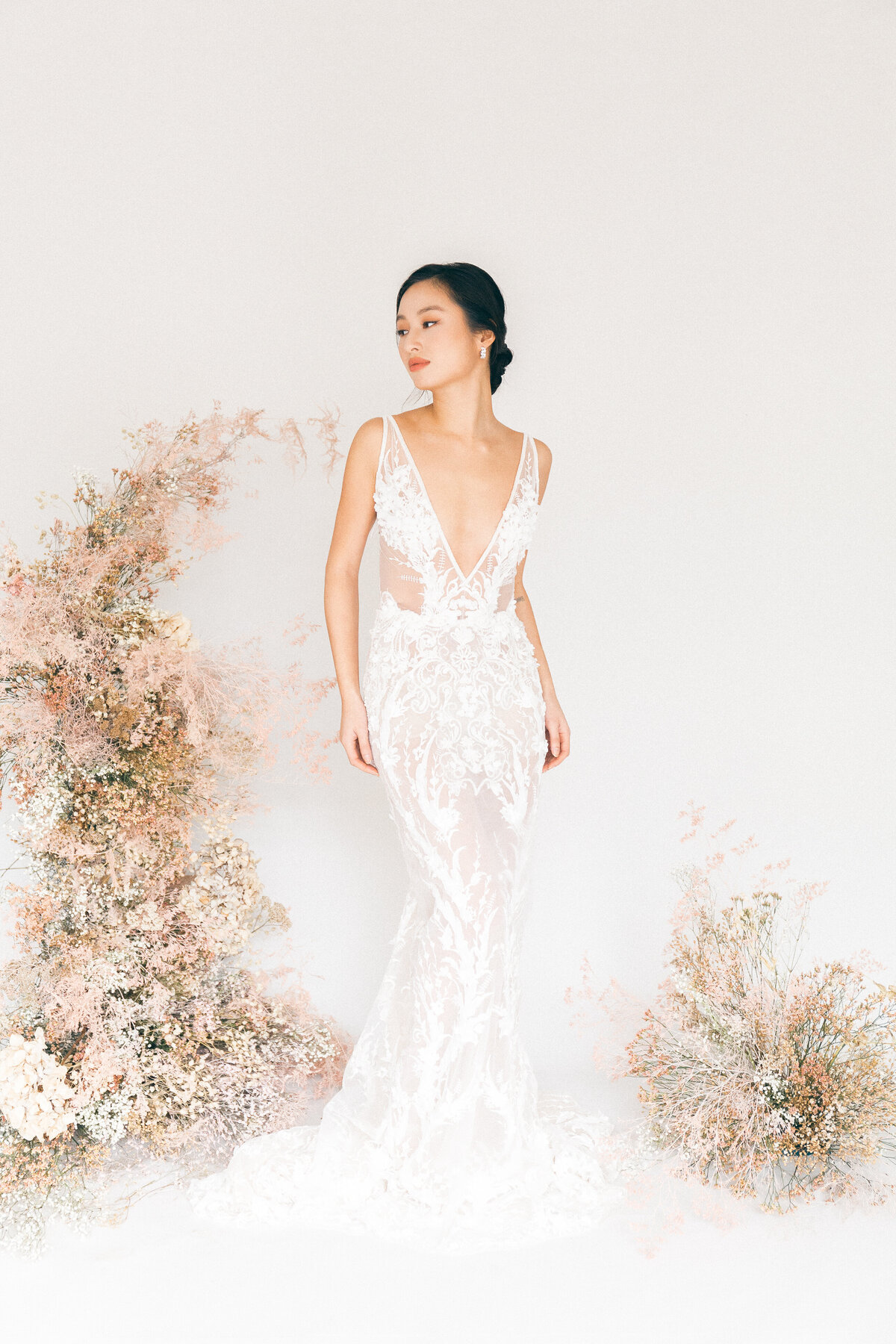 Editorial portrait of a woman wearing a white dress