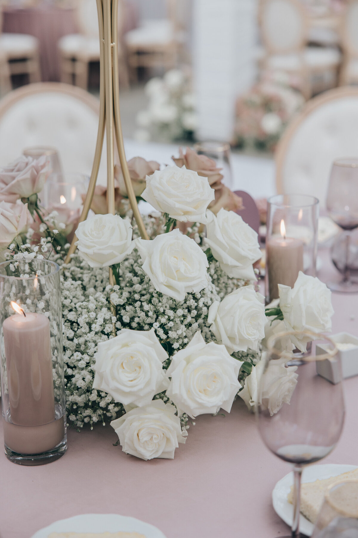 Elegant white roses and lavender glassware for glamorous wedding dinning