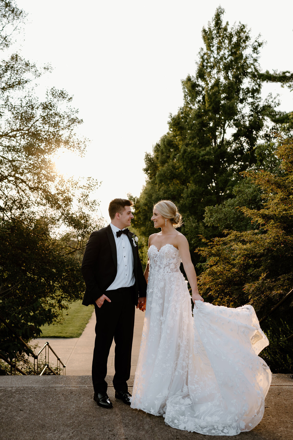 bride and groom standing in the sunlight on their wedding day 