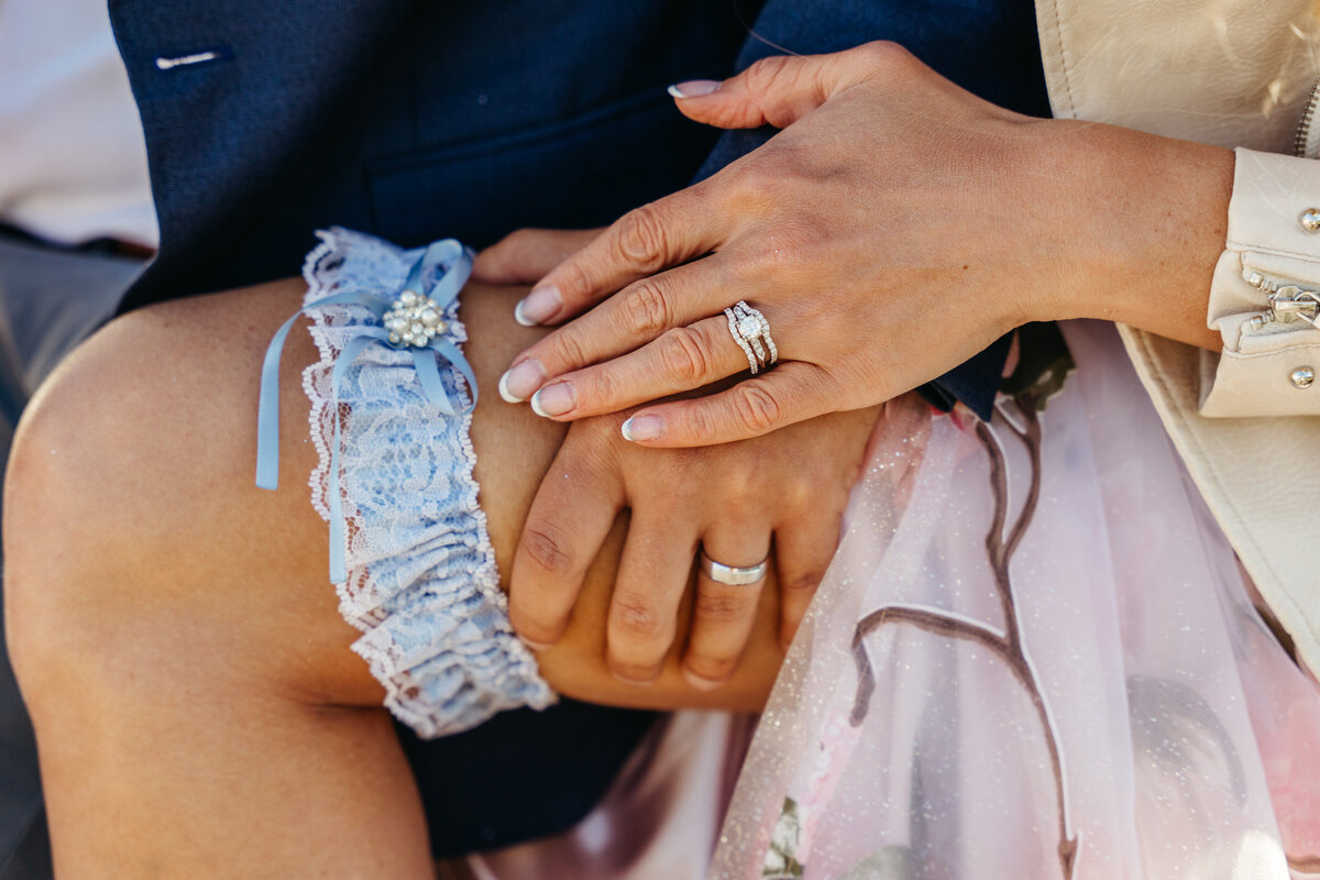 Bride’s engagement ring close-up while holding Vespa handlebar