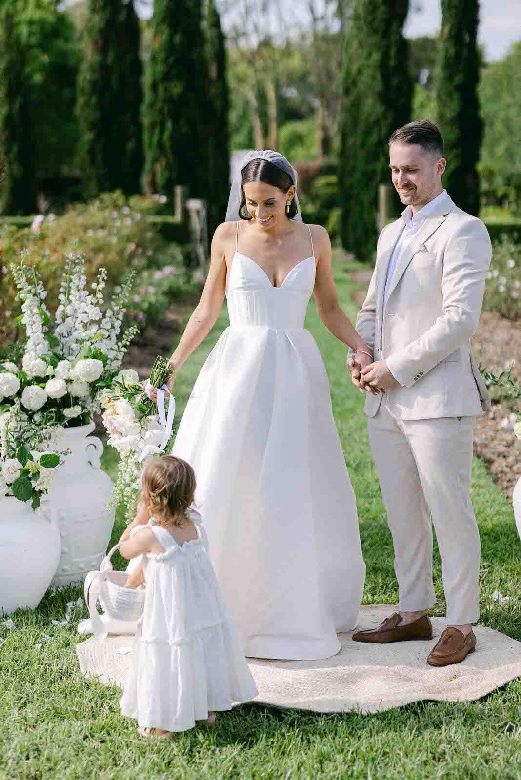 wedding couple with the flower girl