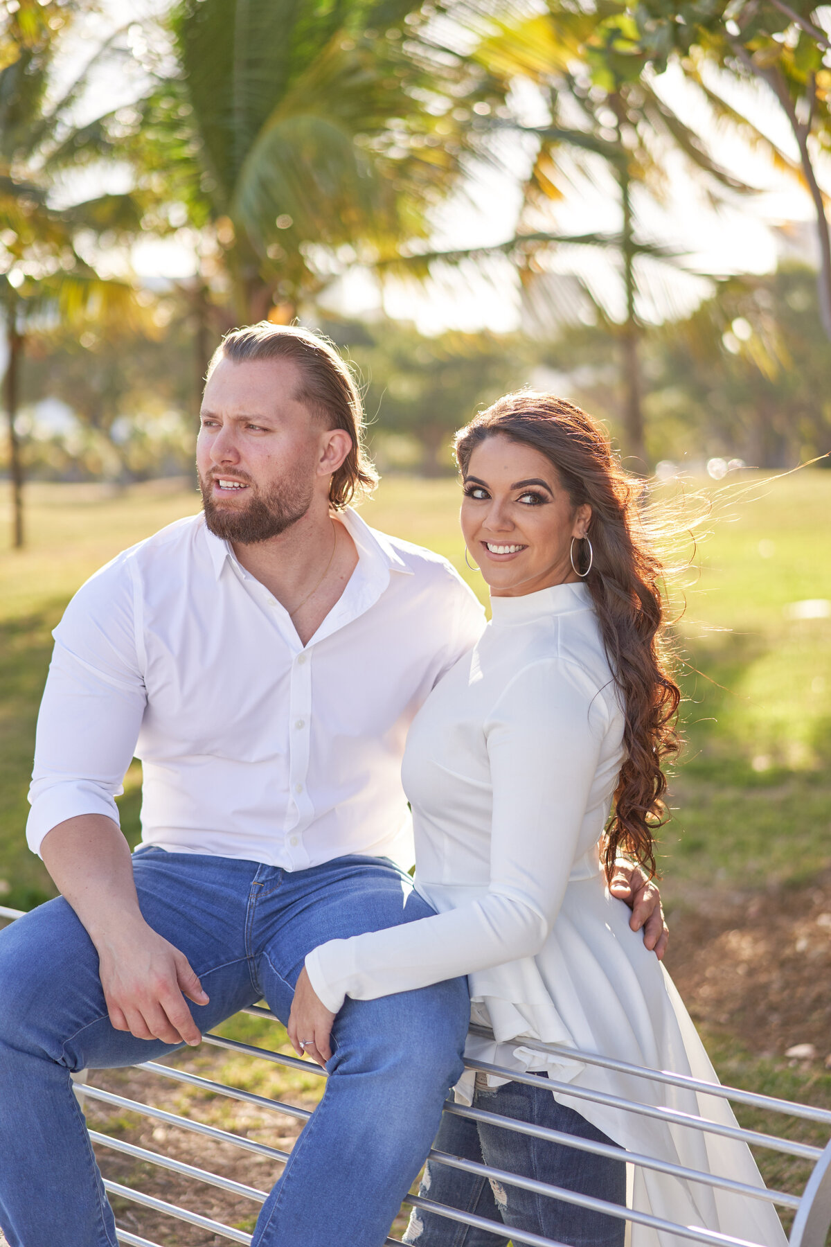 couple-sitting-on-metal-bench-miami-florida