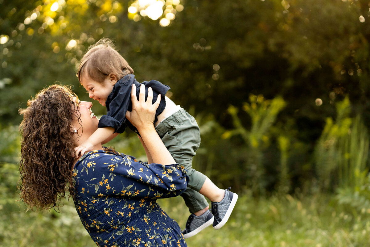 Mother holding young son in the air by Atlanta family photographer Leanne Hymes