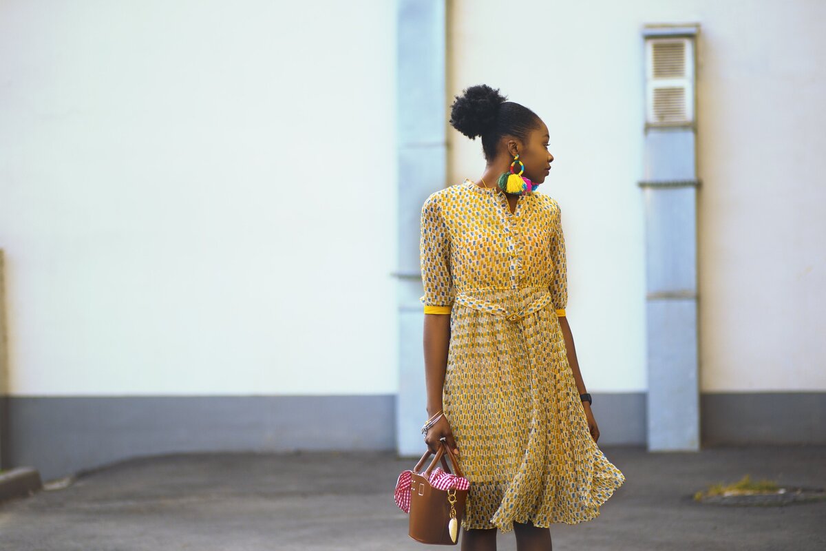 woman-doing-pose-wearing-yellow-dress-1416378