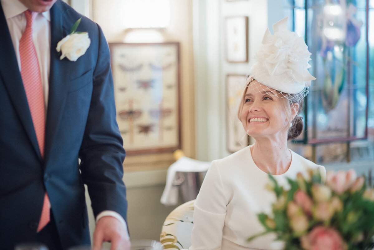 A bride with a huge smile looking at her new husband  taken by London Wedding Photographer Liberty Pearl