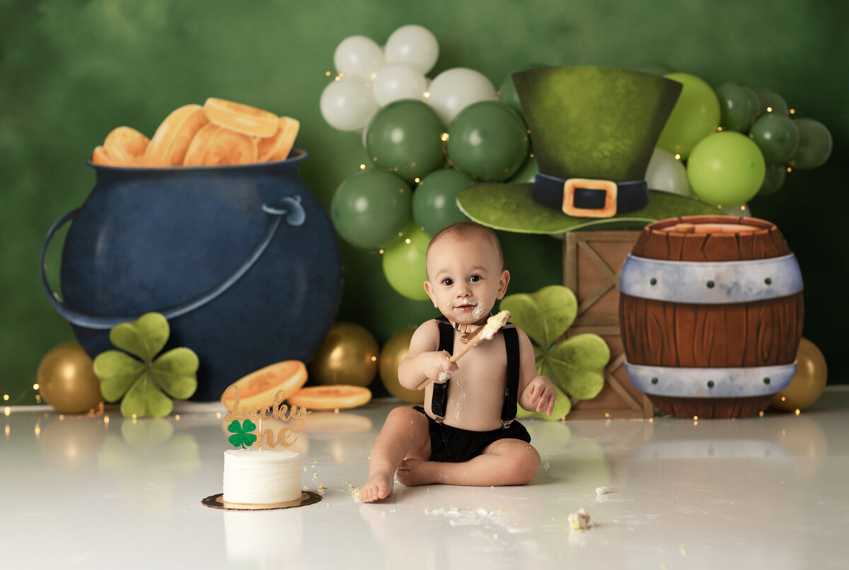 One year old Tampa baby enjoying a personalized luxury cake smash session with playful decorations