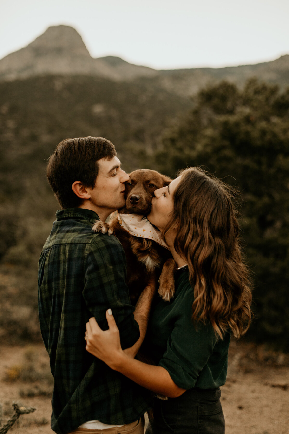 engaged couple holding dog at the Albuquerque foothills in New Mexico