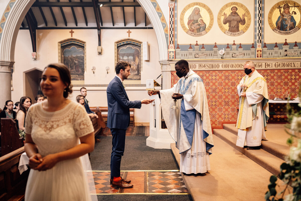 Bride and groom receiving communion during church service