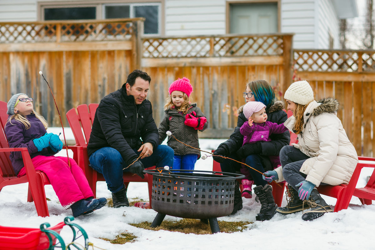 Family roasting marshmallows in the winter