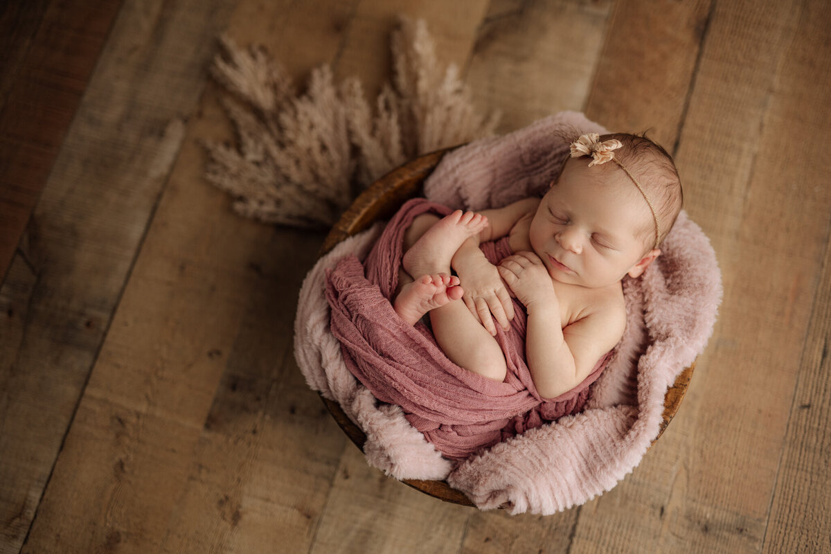 baby girl wrapped in pink in prop at Pittsburgh newborn photos