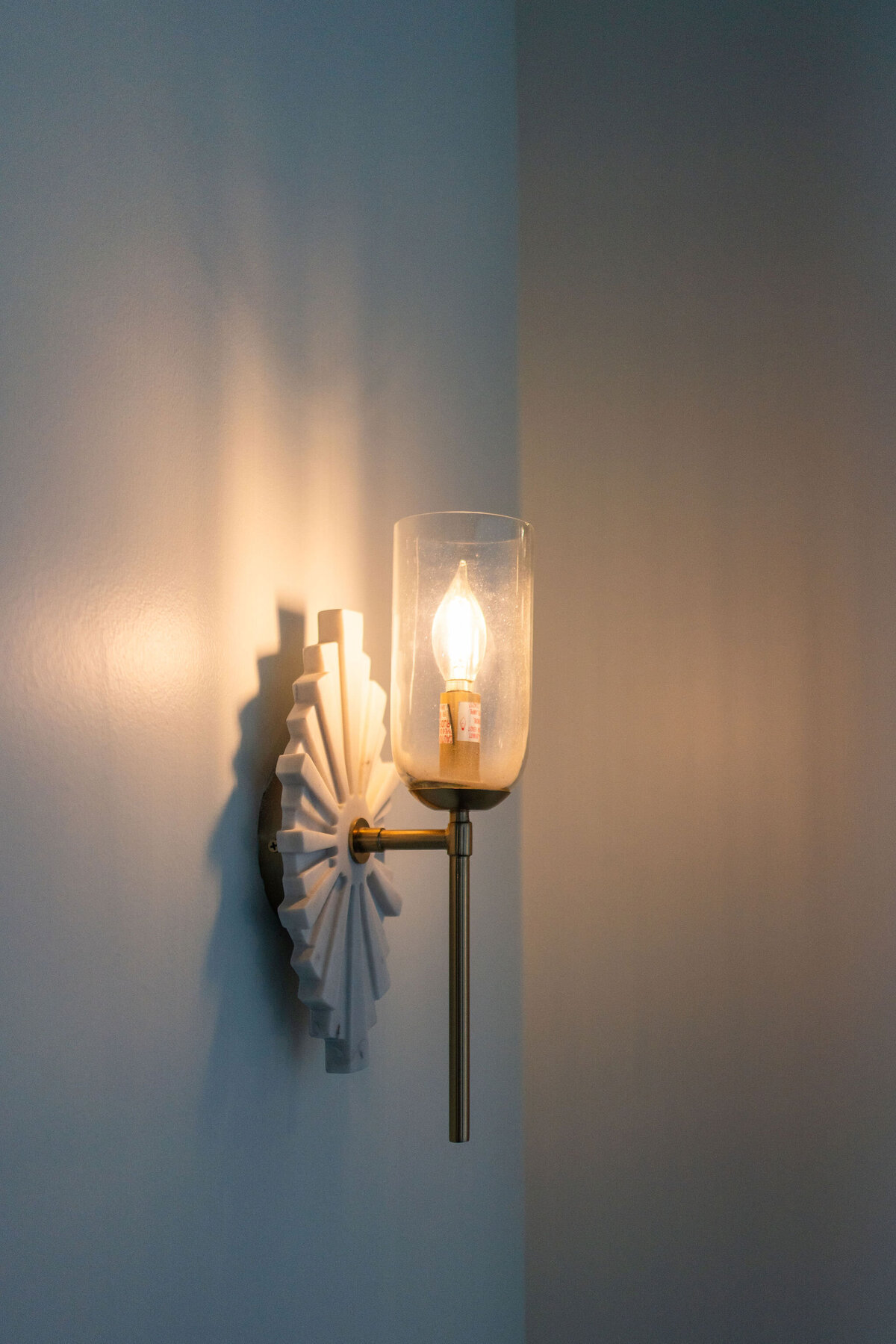 Close-up of a detailed wal sconce scattered throughout the Happy Hour space, adding elegance and attention to detail