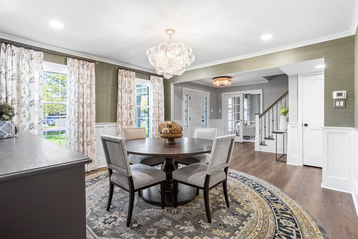 round dining table and chairs with bright lighting fixture