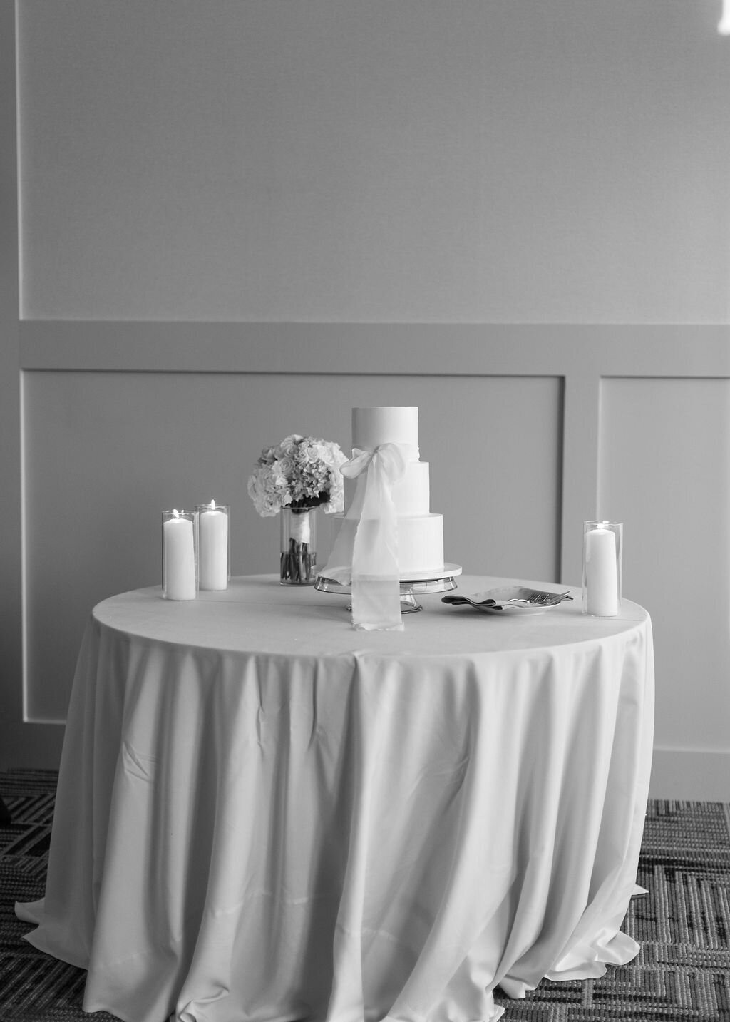Elegant three-tier white wedding cake with bow at Arizona Biltmore reception.