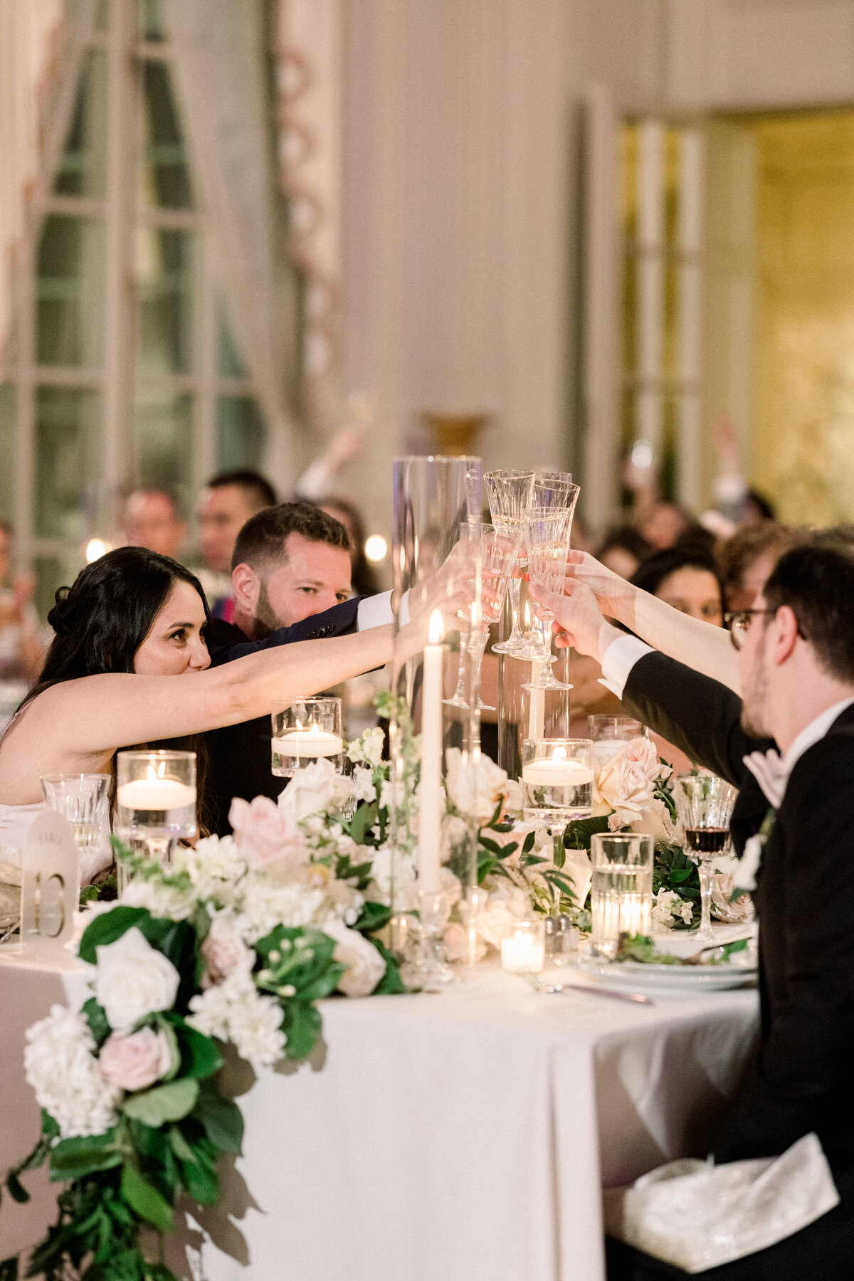 guests cheers during toasts during speaches at rosecliff mansion