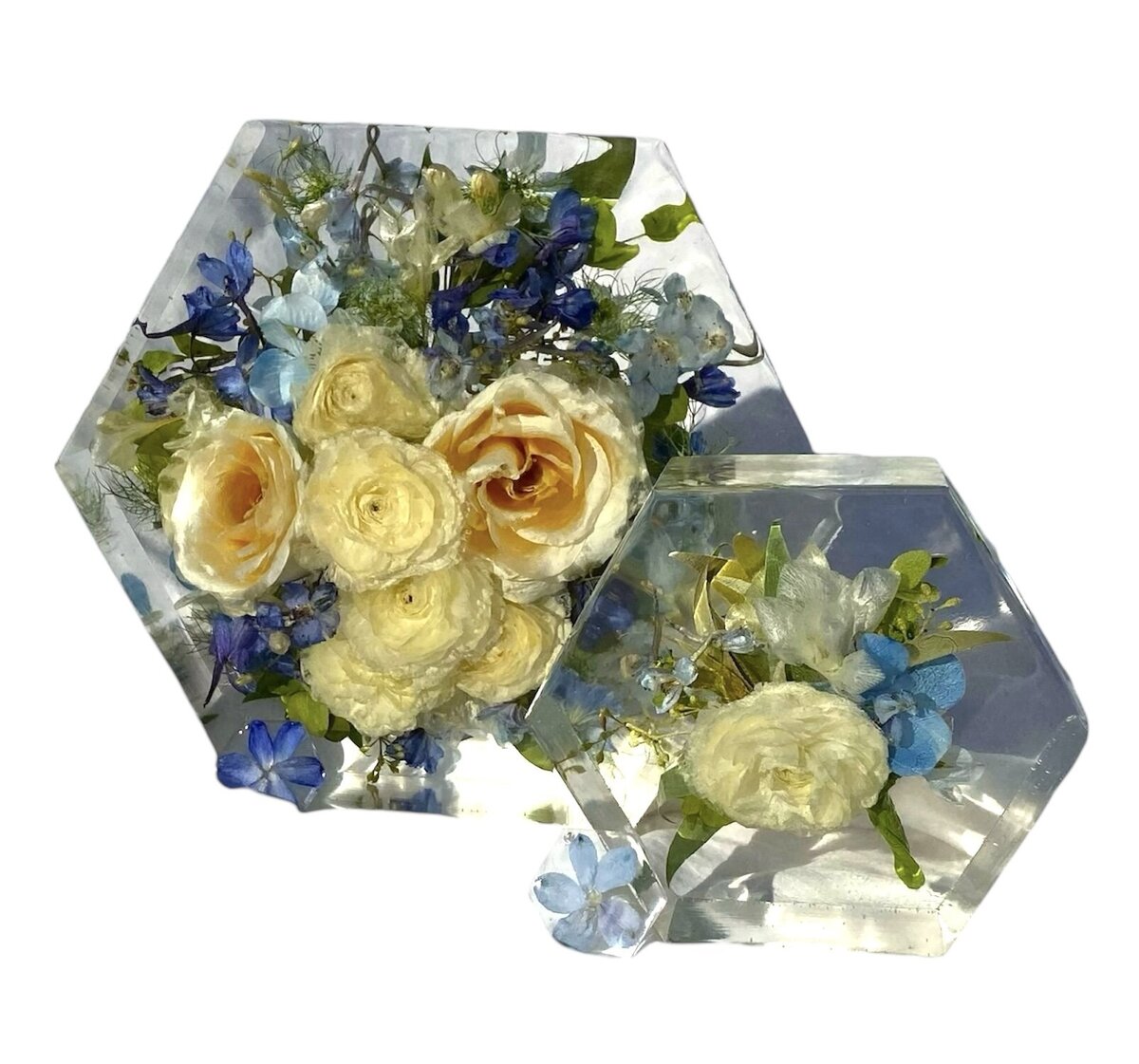 hexagon resin block with blue and cream wedding flowers preserved alongside grooms boutonniere as a timeless family keepsake