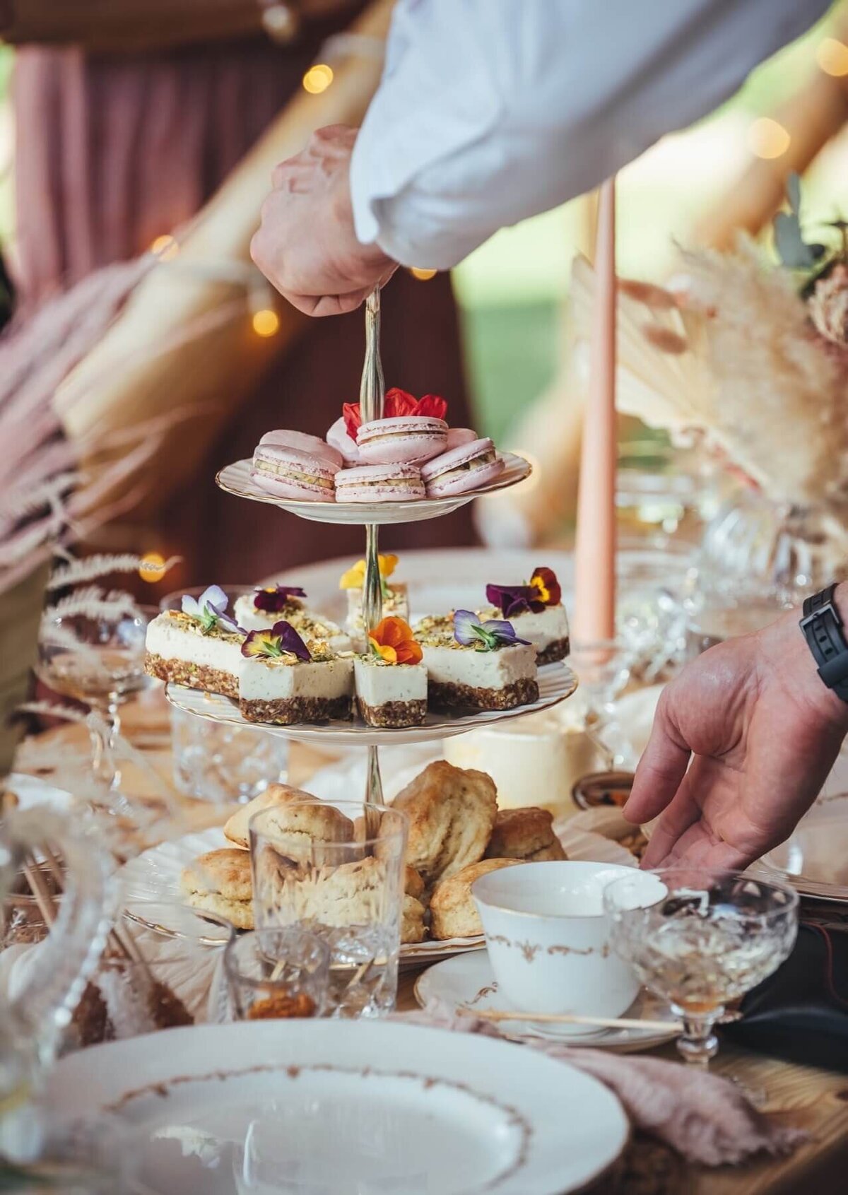 Maharani sweets on cake stand with macaroons and scones