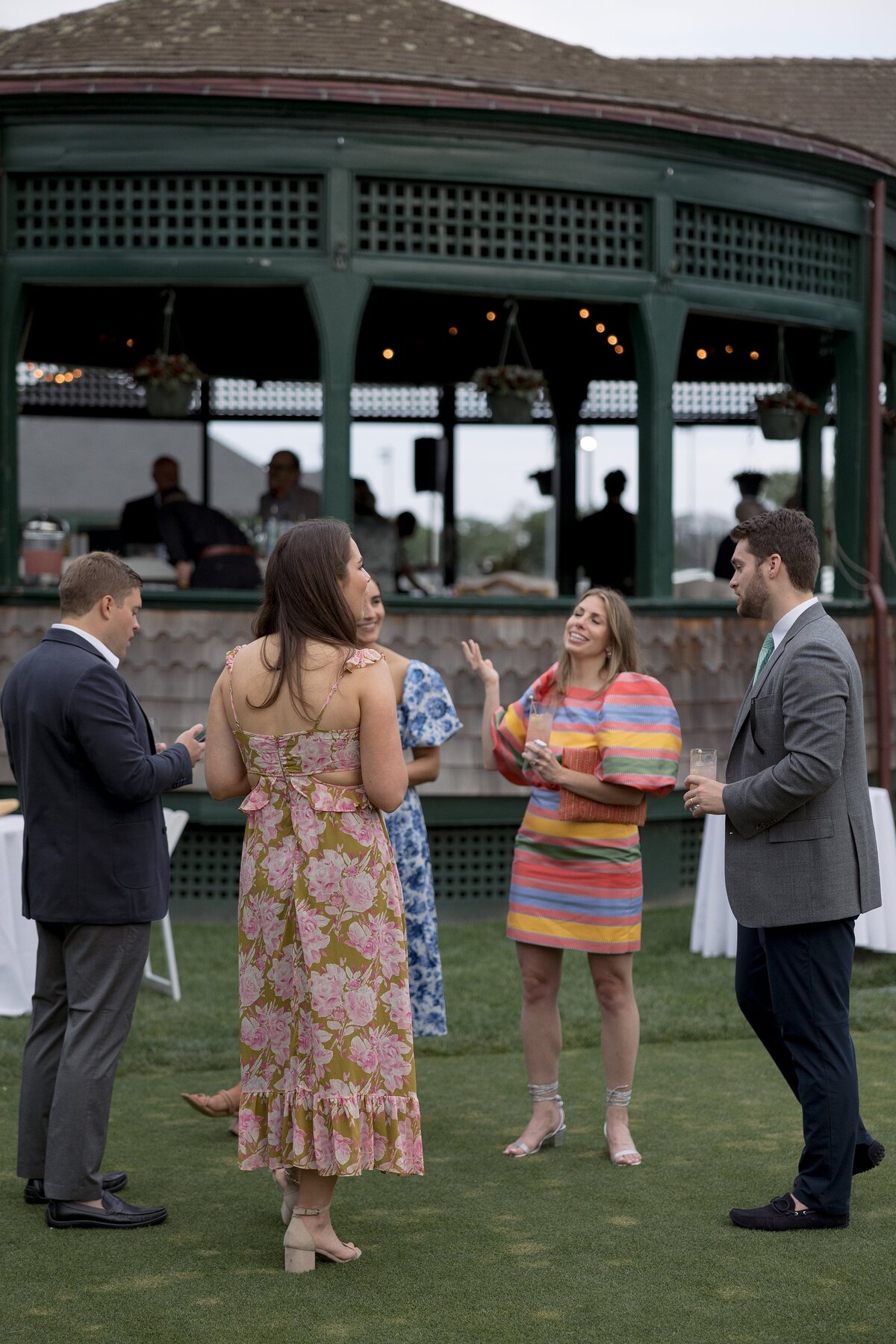 Guests mingle on the lawn of the Tennis Hall of Fame  in Newport during a welcome party. 
