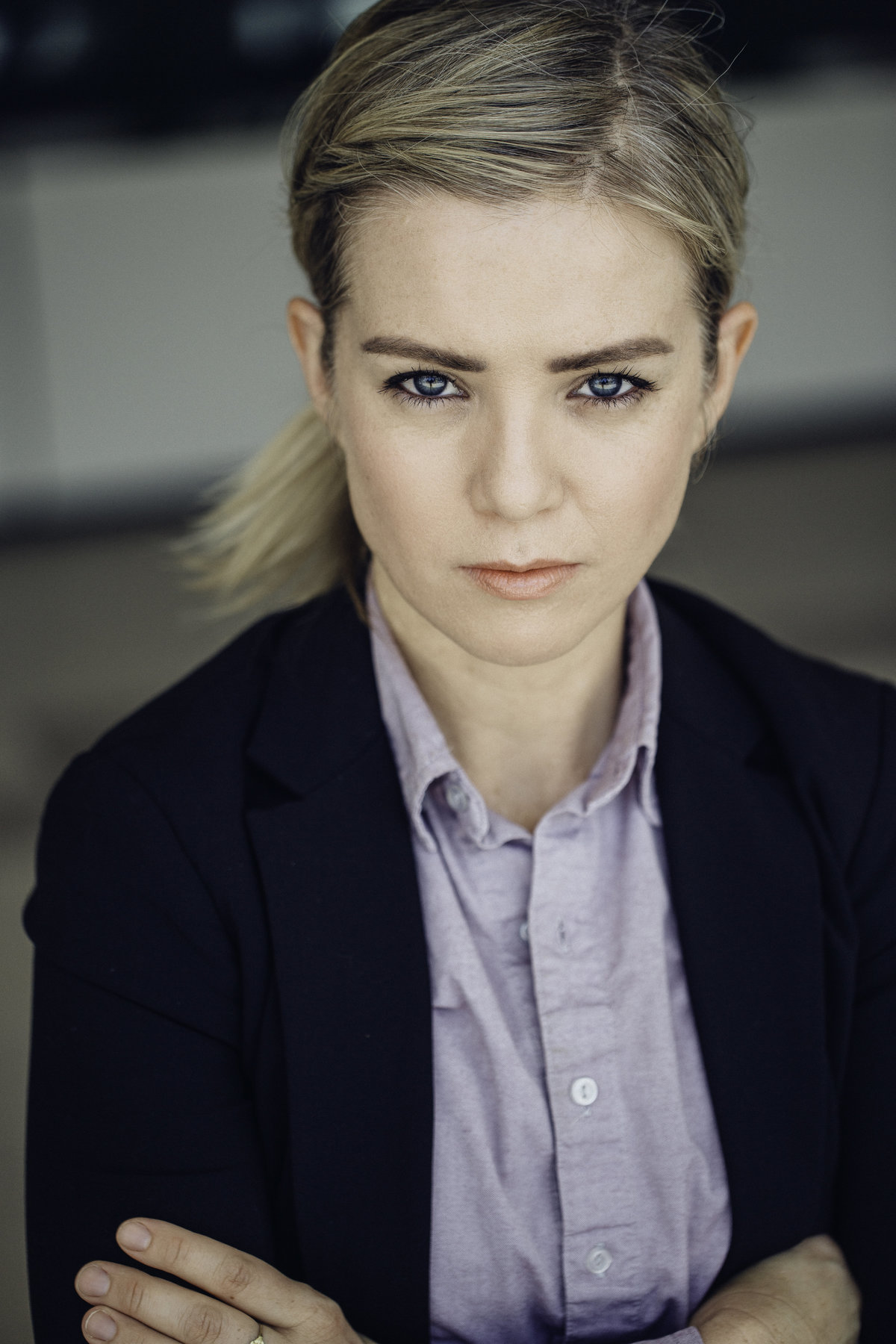 Headshot Photograph Of Young Woman In Outer Black Blazer And Inner Violet Polo Los Angeles